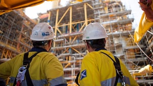 Two men looking at construction of a platform