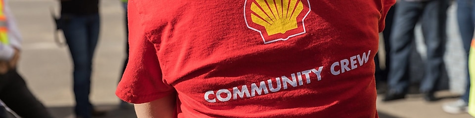 A Groundbirch employee wears a red shirt with the words ‘community crew’ across the back.