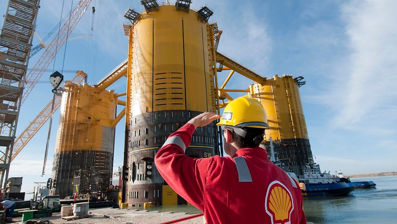 Engineer looking up at platform under construction