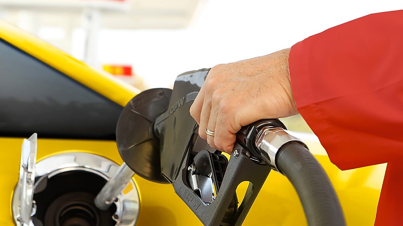 person filling fuel at fuelstation