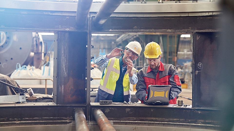 Shell worker consulting an industry worker on site