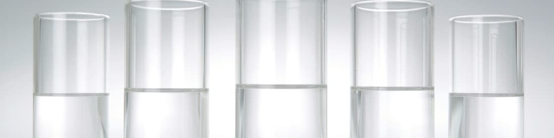 Five beakers in a row with a clear liquid in each one