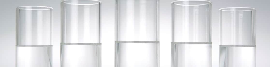 Five beakers in a row with a clear liquid in each one