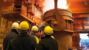 two workers in a metal factory