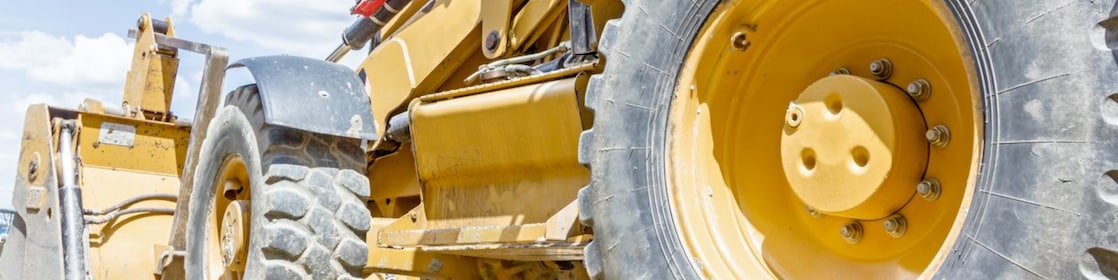 a digger truck under a flyover which is under construction