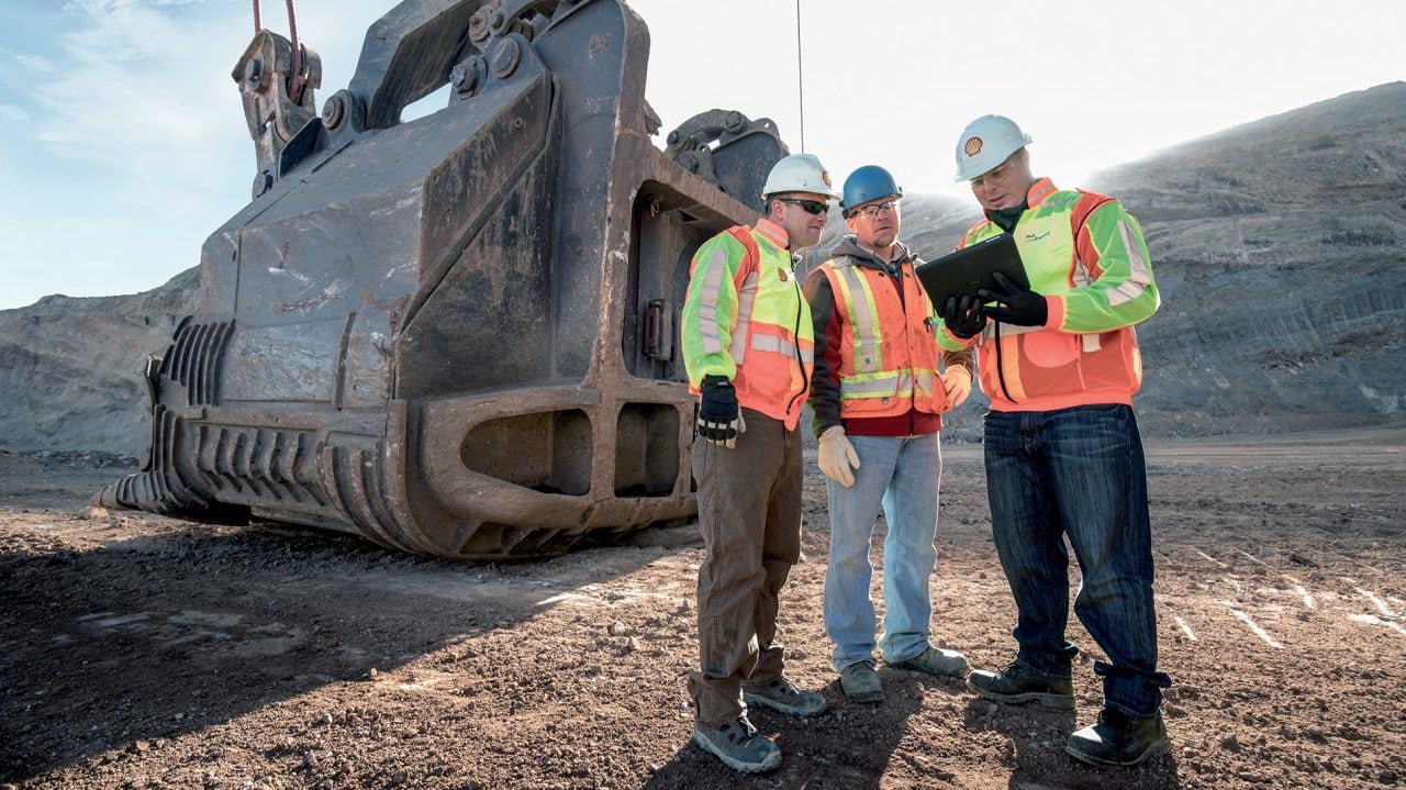Employees discussing about project on site
