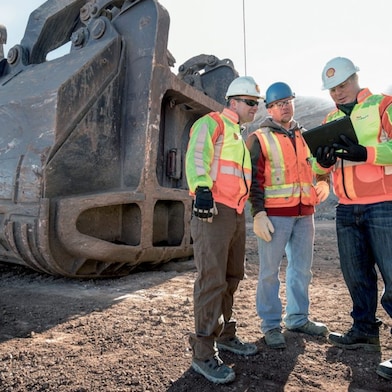 Employees discussing about project on site