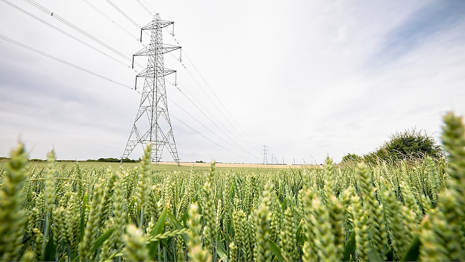Transmission tower in countryside landscape