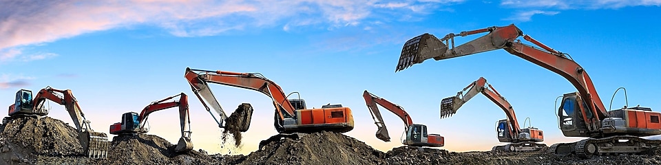 Industrial excavator's digging sand with blue background