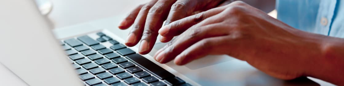 man typing on laptop