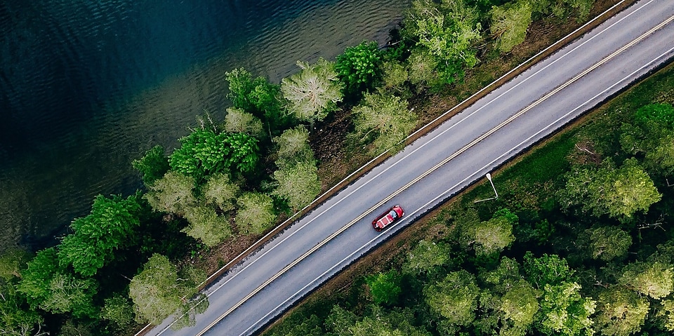 Overhead shot of a car on a road with a yellow waypoint