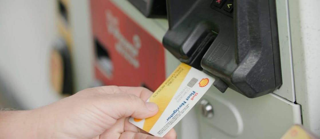 Person inserting Shell Fleet Navigator card at the pump