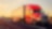 Two commercial transport semi-trucks driving on a remote highway.