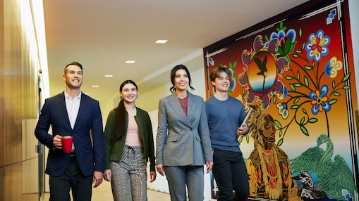 Diverse colleagues walking through an office hallway