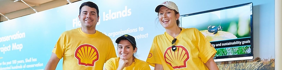 A group of Shell employees smiling at a community event.