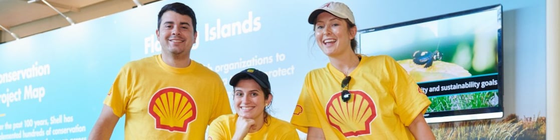 A group of Shell employees smiling at a community event.
