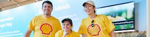 A group of Shell employees smiling at a community event.
