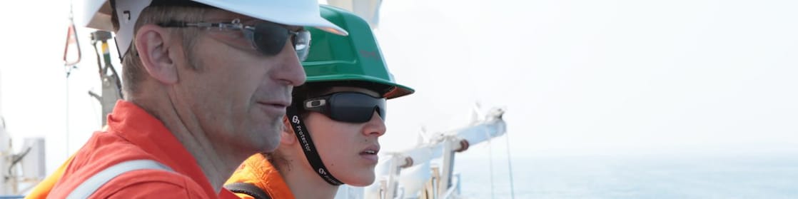 man and woman watching from ship