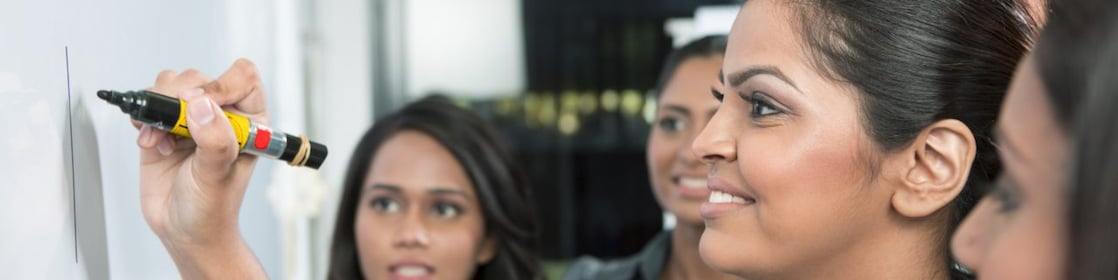 Business leader writing on whiteboard