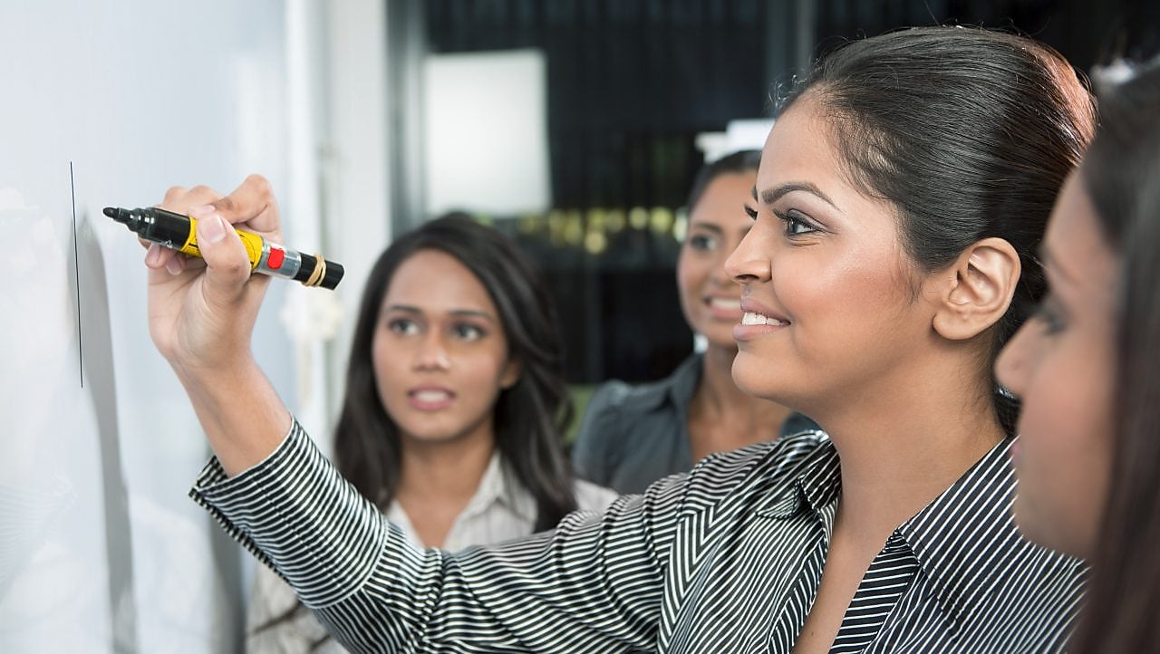 Business leader writing on whiteboard
