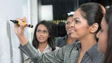 Business leader writing on whiteboard