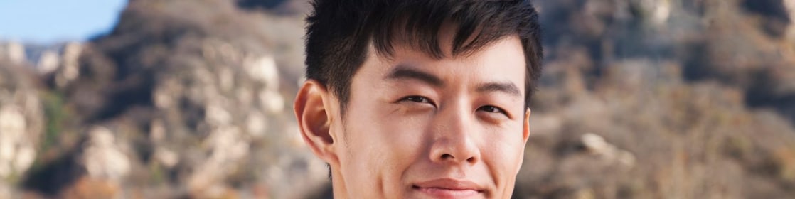 man with binoculars in rural landscape