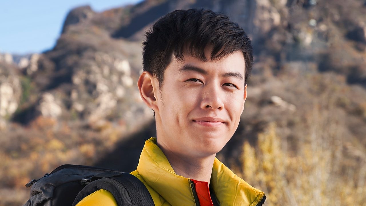 Man with binoculars in rural landscape