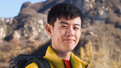 Man with binoculars in rural landscape