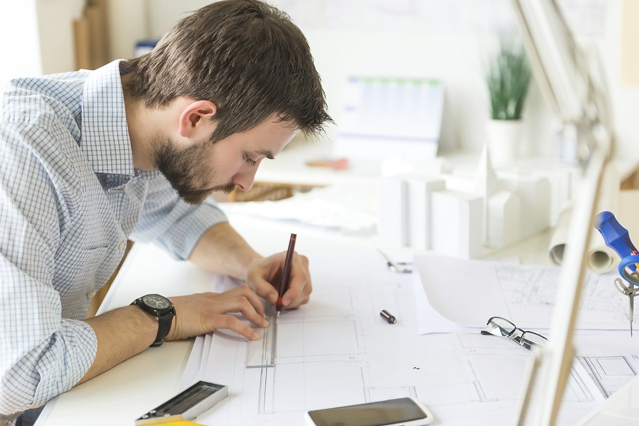 young architect drawing something on paper