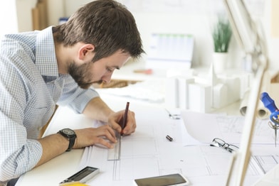 young architect drawing something on paper