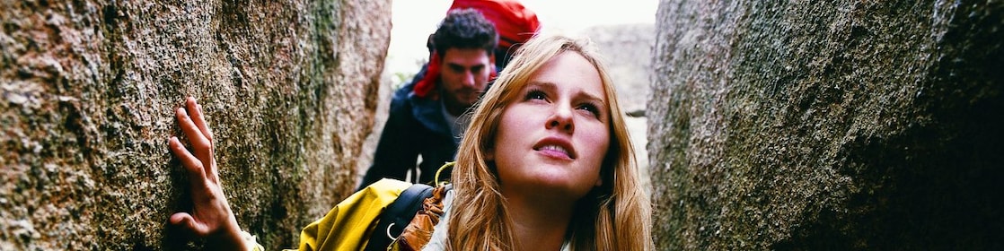 Two People Orienteering Between Rocks