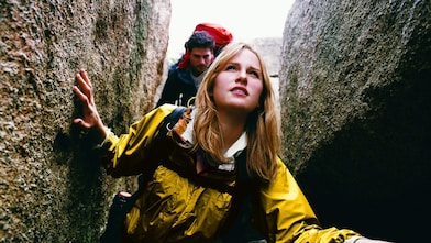 Two People Orienteering Between Rocks