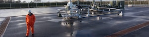 man walking beside a mechanical unit