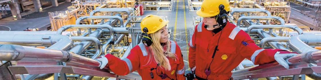 Two shell employees talking at work site