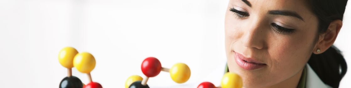 scientist looking at molecule model