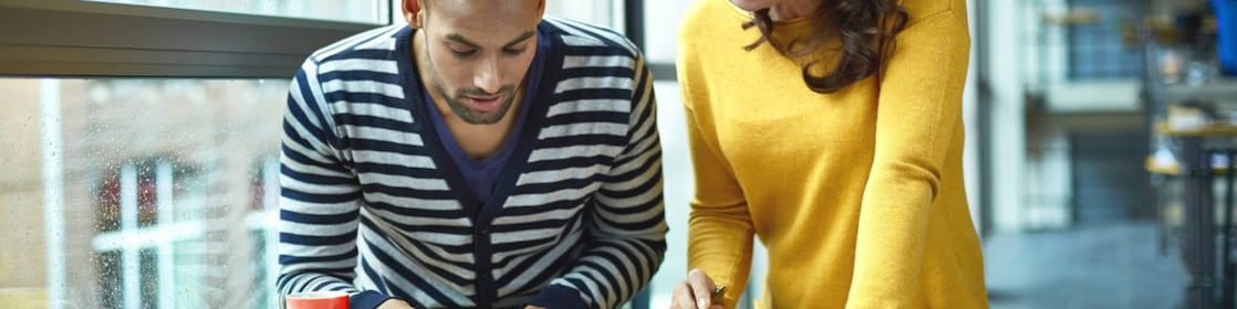 Two architects discussing project at high table