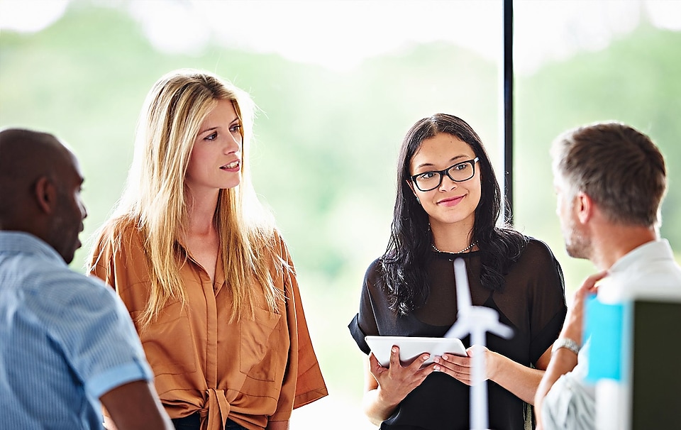 A female experienced professional at Shell smiling during a meeting.