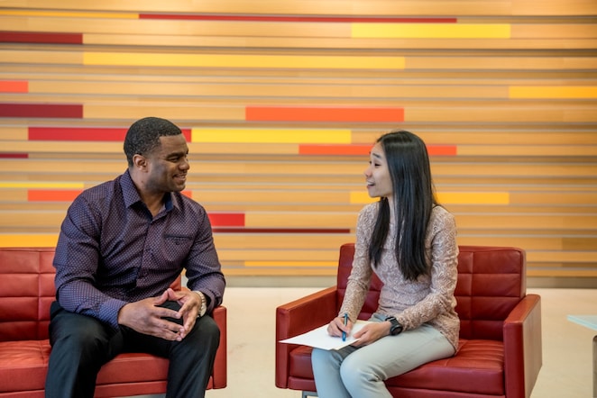 two individuals discussing