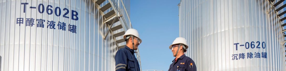 Two Asian Shell engineers meeting at an operational site.