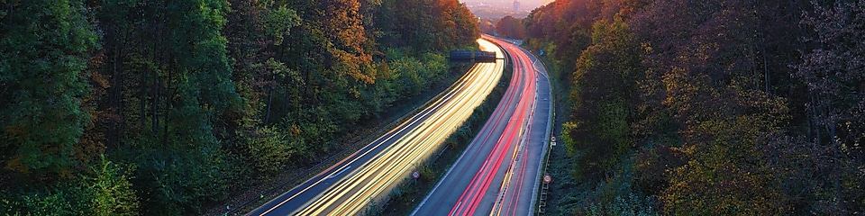 Light trails traffic, mountain road at dusk
