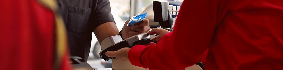 A person is making payment using Air Miles credit card