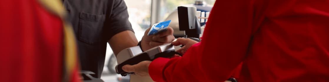 A person is making payment using Air Miles credit card
