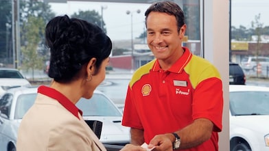 Customer tapping card at cashier counter