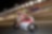 Ducati rider riding motorcycle at high speed on a track at night