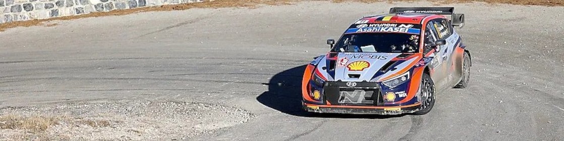 Rally car drifting around a corner in the world rally championship