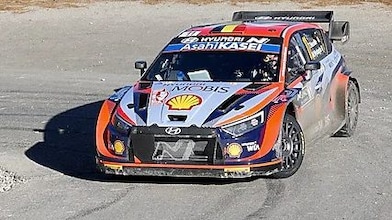 Rally car drifting around a corner in the world rally championship