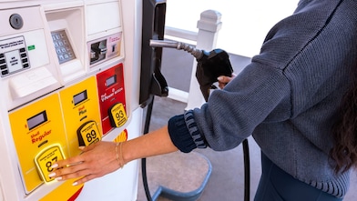 Woman select shell regular gas at a shell gas station