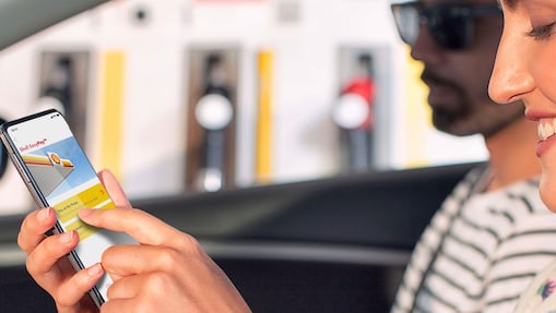 Woman in parked car using Shell EasyPay