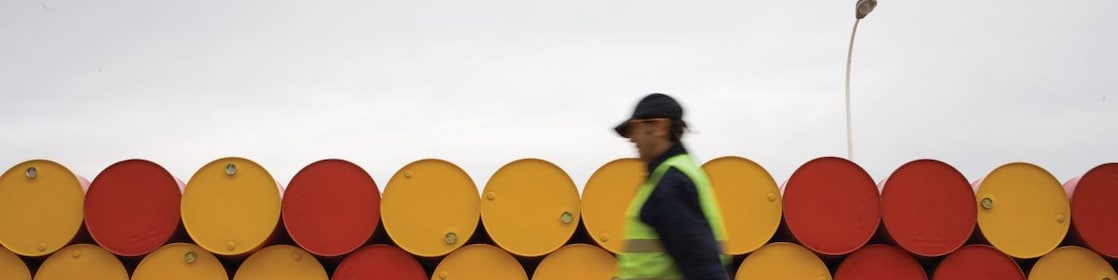 man walking barrels lubricants