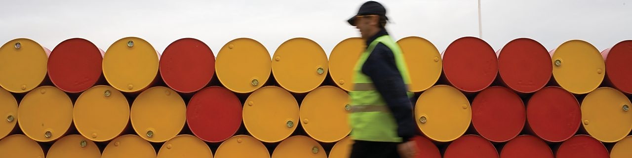 man walking barrels lubricants